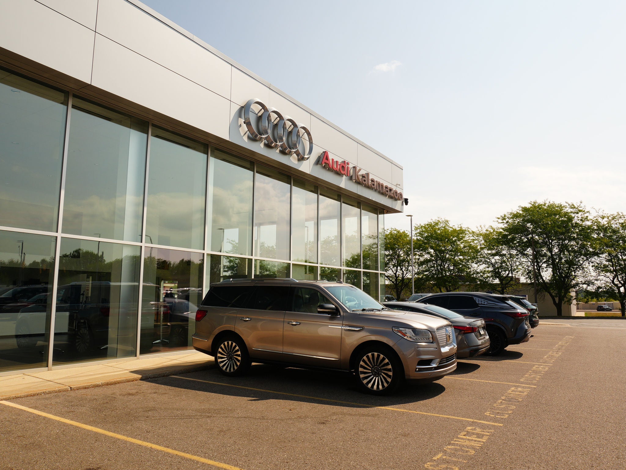 Audi Sale Specialist walking through the showroom with a couple.